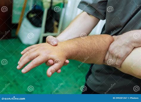 Masseuse Makes Hand Massages For A Man Using Traditional Hand Massage