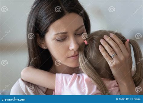 Upset Loving Mother Embracing Comforting Little Daughter Close Up