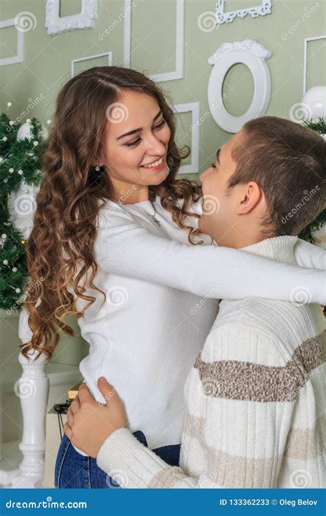 Young Attractive Girl Is Hugging Her Boyfriend And Smiling Stock Image