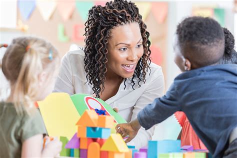 Friendly Teacher Enjoys Playing With Her Preschool Students Stock Photo Download Image Now