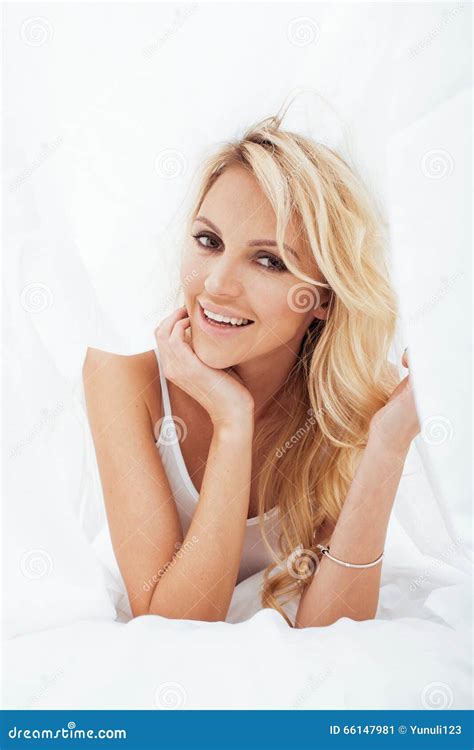 Young Pretty Blond Woman In Bed Covered White Sheets Smiling Cheerful Look Close Up Stock Image