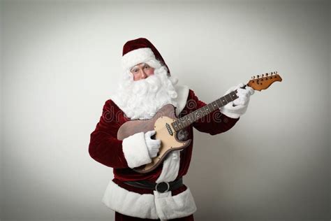Santa Claus Playing Electric Guitar On Light Background Christmas