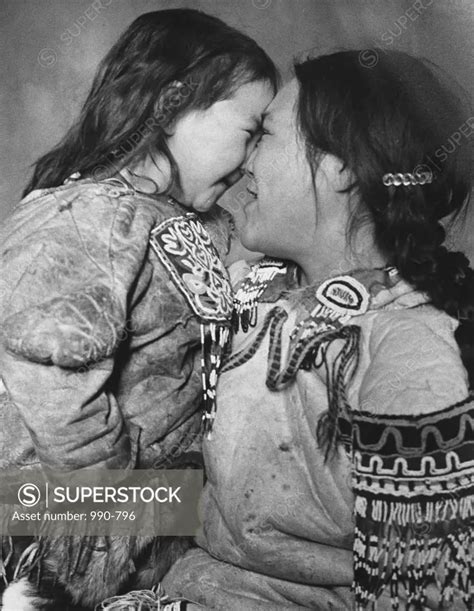 Mid Adult Eskimo Woman And Her Babe Rubbing Noses SuperStock