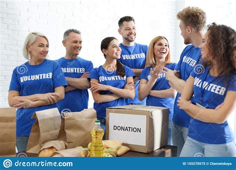 Team Of Volunteers Near Table With Food Donations Stock Image Image