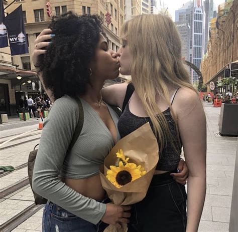two women kissing each other on the street