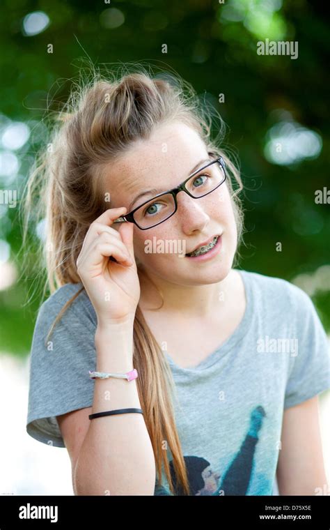 13 Year Old Teenage Girl Wearing Glasses And Dental Braces Stock Photo