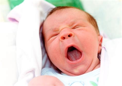Premium Photo Sleepy New Born Baby Yawning With His Mouth Open