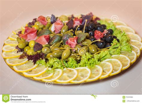 Food Arrangement On Plate With Pickles Olives Greens Bacon Lemon