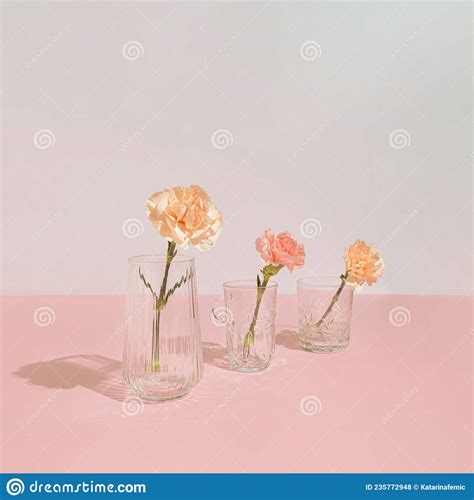 modern pastel pink composition with flowers vase and crystal glasses minimal style romantic