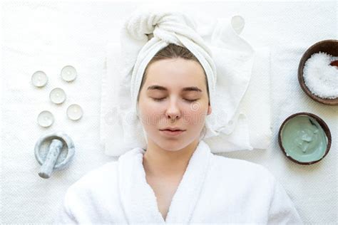 Top View Of A Relaxed Woman With Closed Eyes Having Spa Procedures Using Natural Cosmetics Stock