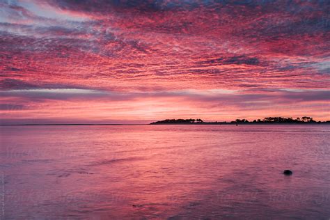 Pink Dawn Sky Reflected In The Surface Of The Sea Norfolk Uk By