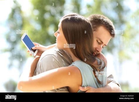 Girlfriend Cheating Texting On The Phone And Hugging Her Innocent