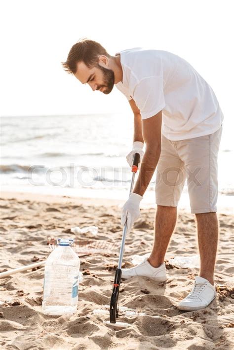 Photo Of Male Volunteer Cleaning Beach Stock Image Colourbox