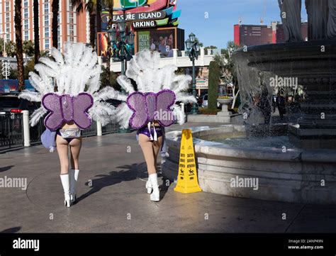 Two Ladies Dressed As Showgirls Walk Along The Strip In Las Vegas