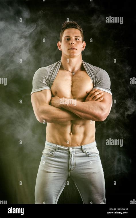 Confident Attractive Young Man With Open Vest On Muscular Torso