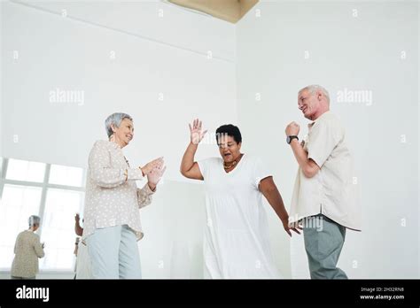 Senior People Dancing To Music During Lesson In Dance Studio Stock