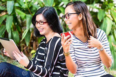 two asian girlfriends with tablet computer stock image image of glasses indonesia 36009053