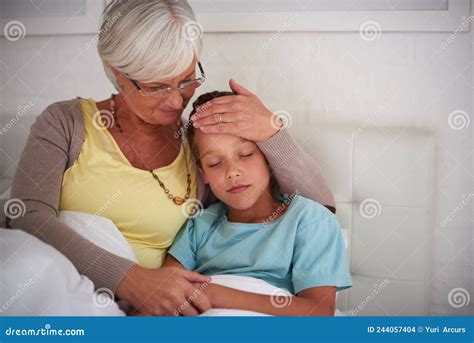 Granny Will Take Care Of You Shot Of A Caring Grandmother Taking Care Of Her Sick Grandson At