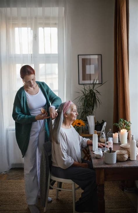 Caregiver Helping Her Client With A Hairstyle Stock Image Image Of
