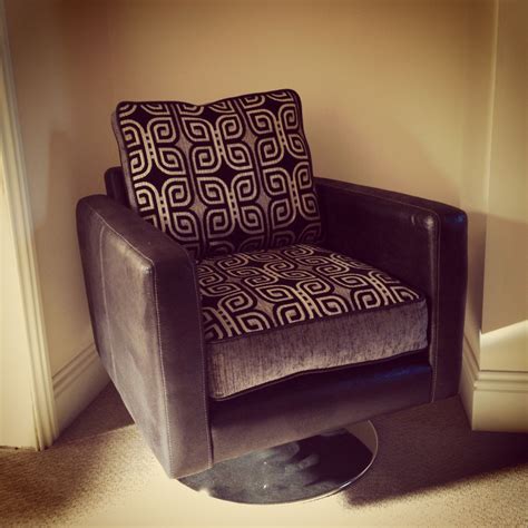 Filigree swivel chair, softly upholstered all around in grey and with black, solid wood legs. Black, silver and grey swivel armchair | Swivel armchair ...