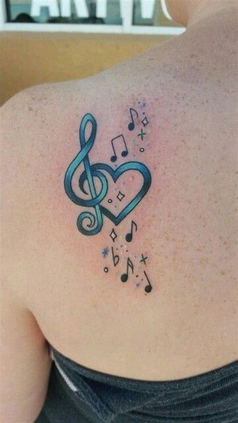 Turquoise Treble Clef With Heart And Notes Tattoo On Shoulder Blade