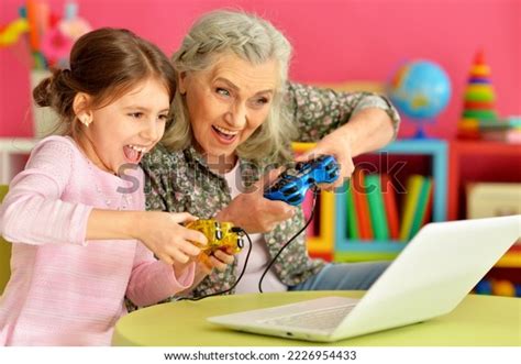 Granny With Her Grandbabe Playing Computer Game Stock Image Image