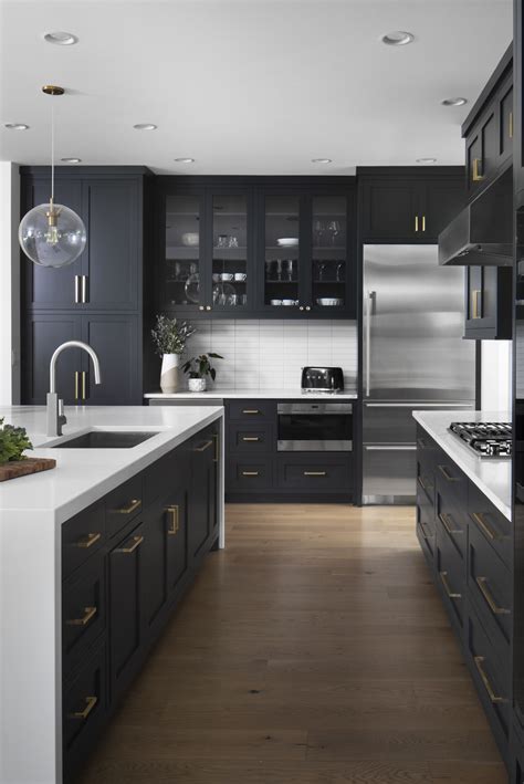 Modern Kitchen White Countertop Dark Cabinet Brushed Gold Accents