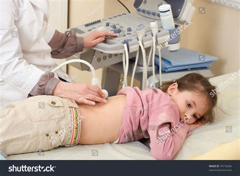 Medical Exam Of A Little Girl By Ultrasound Equipment Stock Photo