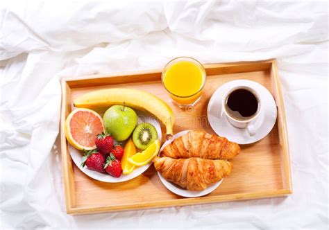 Breakfast In Bed Tray With Coffee Croissants And Fruits Stock Photo