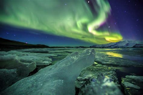 Auroral Over The Glacier Lagoon Jokulsarlon In Iceland Encompass The