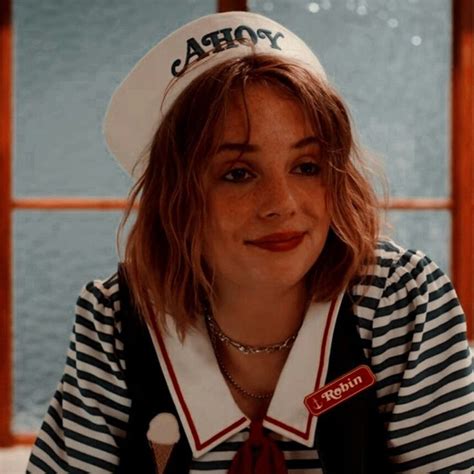 A Woman Wearing A Sailors Hat And Striped Shirt