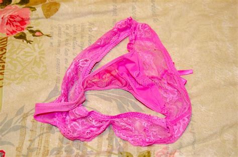 Female Pink Used Panties String On The Bed Fetish Stock Photo