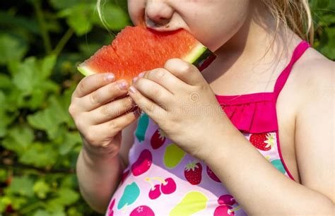 Cute Little Girl Eating Watermelon In The Summertime Stock Image