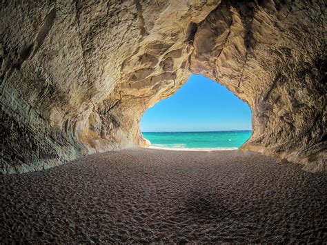View Of Turquoise Sea From Beach Cave Sand Sea Caves Beaches