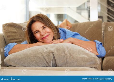 Smiling Older Woman Relaxing At Home On Sofa Stock Photo Image Of