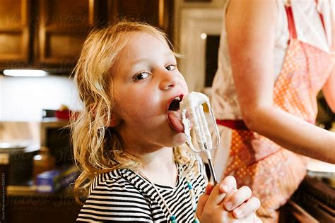 Girl Licking Food Off Mixing Utensil By Stocksy Contributor Carey Shaw Stocksy