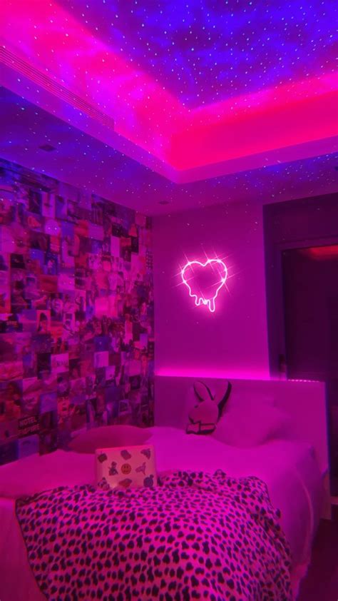 A Bedroom With Pink And Purple Lights On The Ceiling