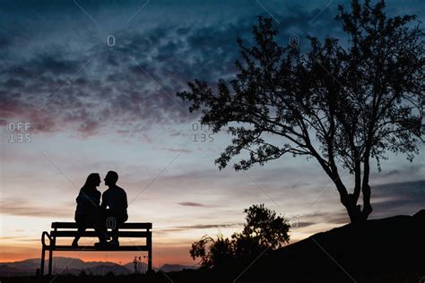Silhouette Couple Sitting On Bench