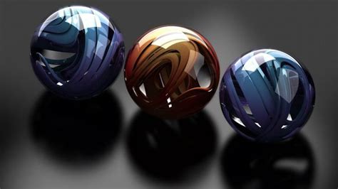 Three Different Colored Balls Sitting Next To Each Other On A Black
