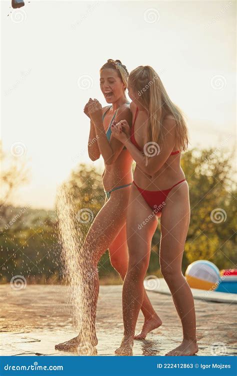 two female friends sharing outdoor shower by the swimming pool stock image image of sharing