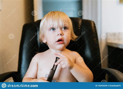 Adorably Precious Cute Little Blond Toddler Boy With Long Hair Getting
