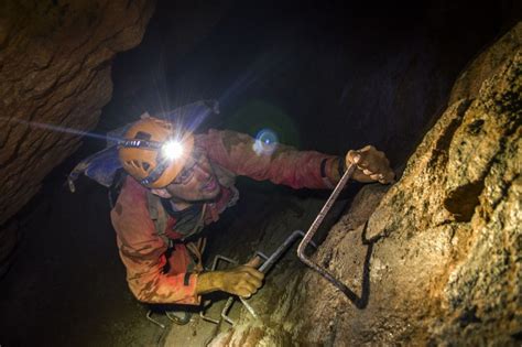 Climbing A Ladder Above A Deep Mine Shaft On The Underground Adventurer