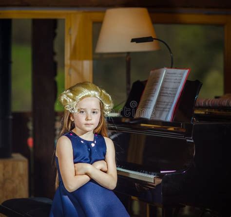 Cute Little Girl Playing Piano Dressing In Retro Mozart Periwig Stock