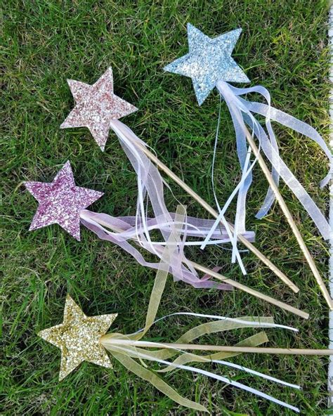 Five Glitter Star Wands Laying In The Grass