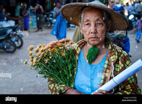 Old Burmese Woman Walking In The Streets Of Nyaung U Market Close To