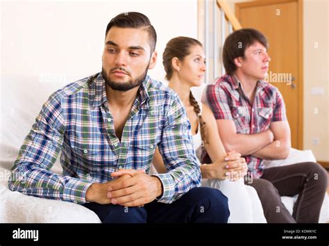 Two Young Men Quarreling Over A Woman At Home Stock Photo Alamy