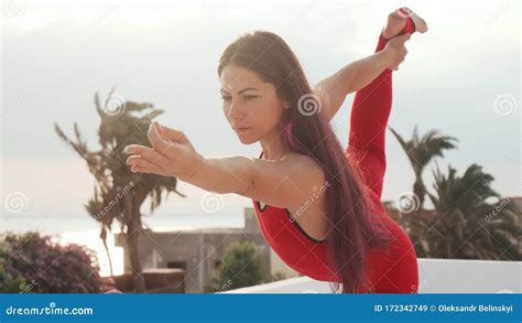 Close Up Young Girl Practice Yoga Standing Bow Pose On Rooftop At