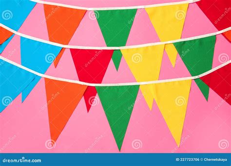 Buntings With Colorful Triangular Flags On Pink Background Festive