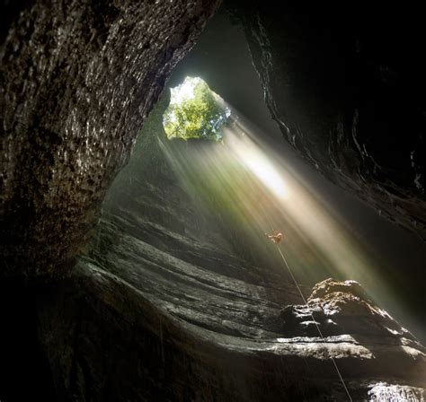 Daredevil Photographer Captures Rainbow As It Shines Into Giant Cave
