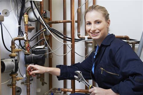 Female Plumber Working On Central Heating Boiler Stock Photo Image Of